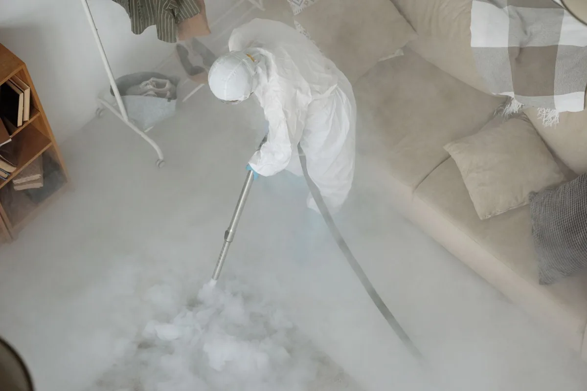 Biohazard cleanup technician in protective equipment, Huntsville, AR